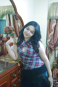 busty indian girl in her bedroom posing