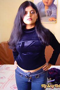 Sexy Indian Neha Nair in bedroom showing her assets off