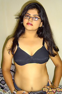 Sexy Indian Neha Nair in bedroom showing her assets off