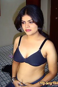 Sexy Indian Neha Nair in bedroom showing her assets off