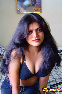 Sexy Indian Neha Nair in bedroom showing her assets off
