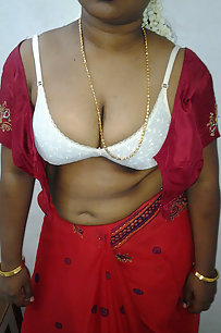mature indian housewife taking her indian outfits off in bedroom